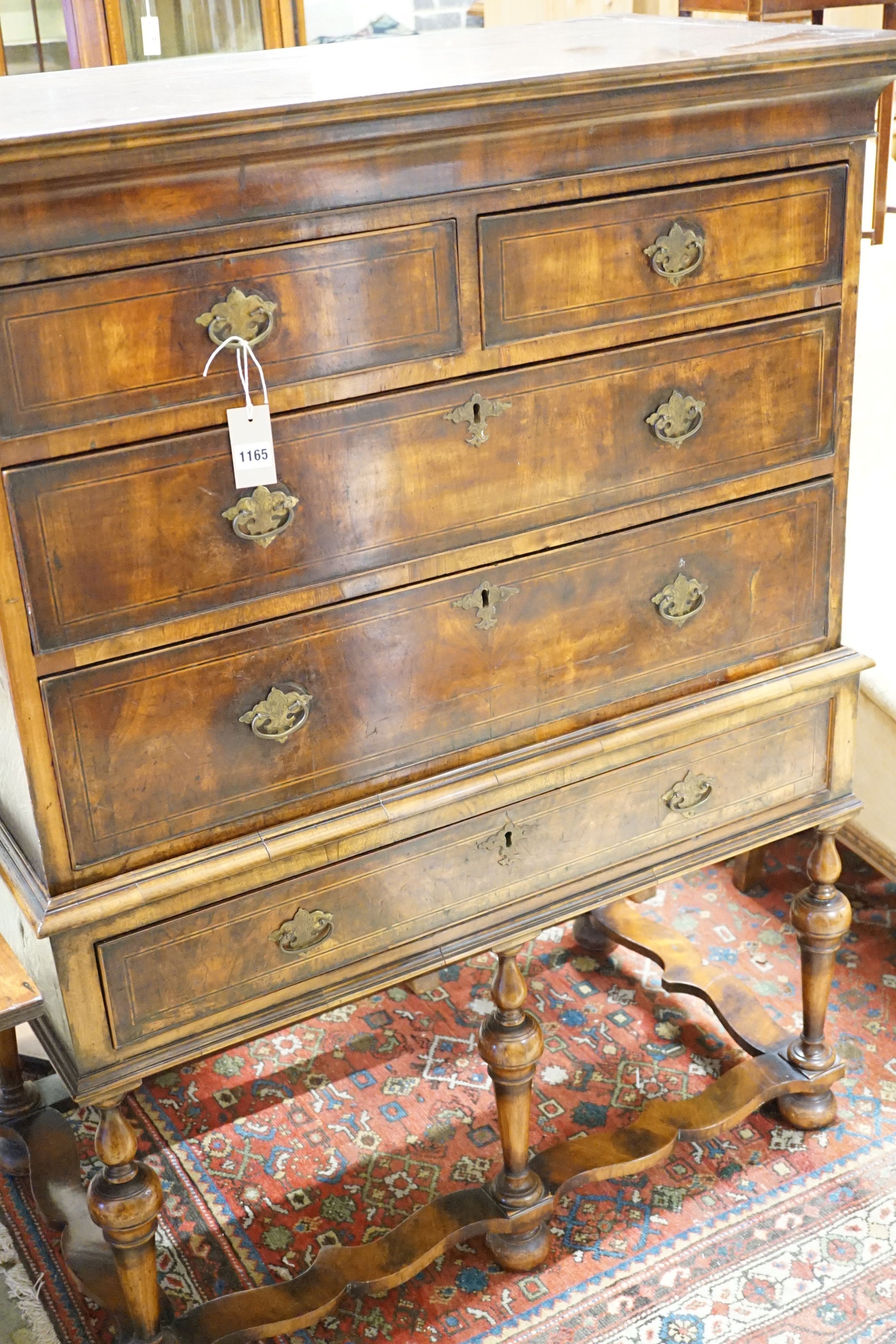 An early 18th century chest on stand with some later timbers, width 104cm, height 133cm